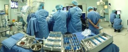 Projects Abroad medical interns observe surgery at a local hospital in Shanghai during their Medicine internship in China. A group of medical interns gather round a surgical table in a hospital at a workshop during their medical placement in China.